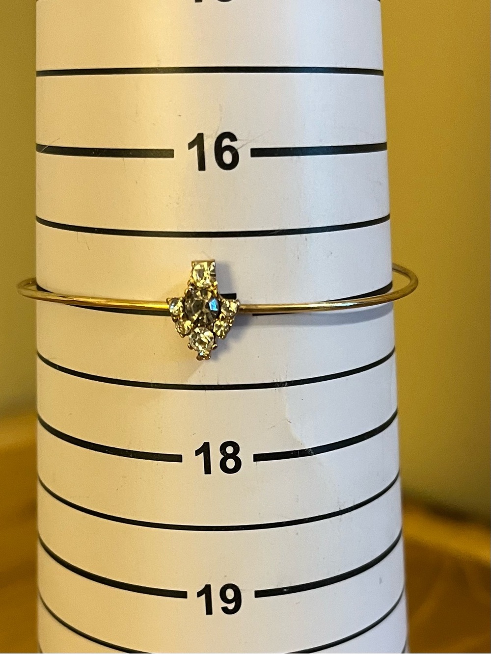 Tiny delicate cuff on gold tone wire band with a smoke & crystal rhinestones 7”